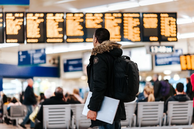 a man trying to figure out where to go in an airport